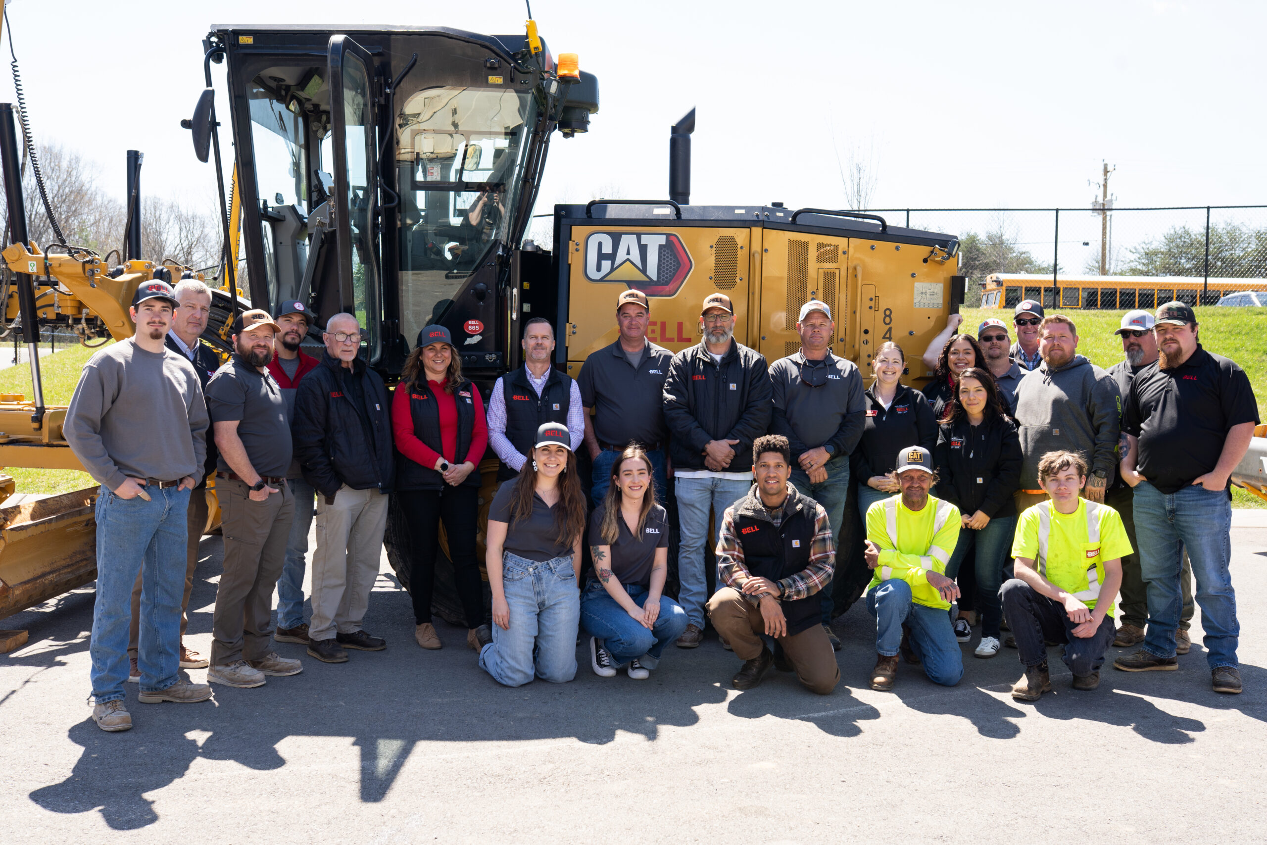 BELL_Future Builders Academy_BELL group, BELL Construction leadership and jobsite professionals pose for a photo in front of a piece of equipment at the company's Future Builders Academy.