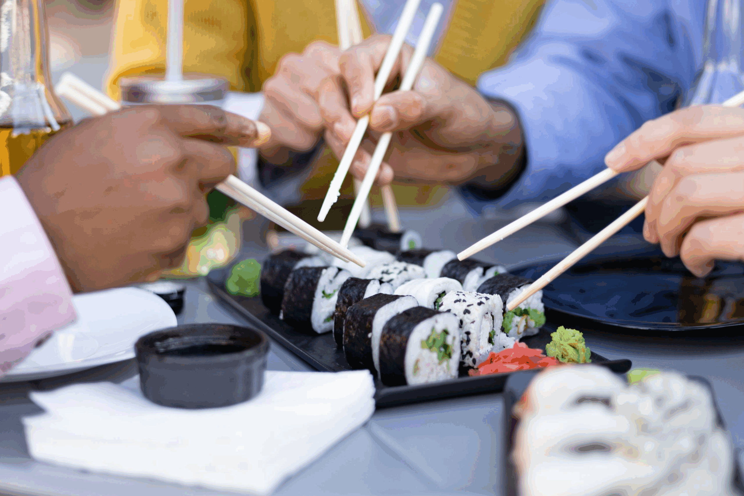 Friends enjoy sushi, dining at a restaurant in Franklin, Tennessee, sushi rolls, Sake and Thai and Japanese cuisine.