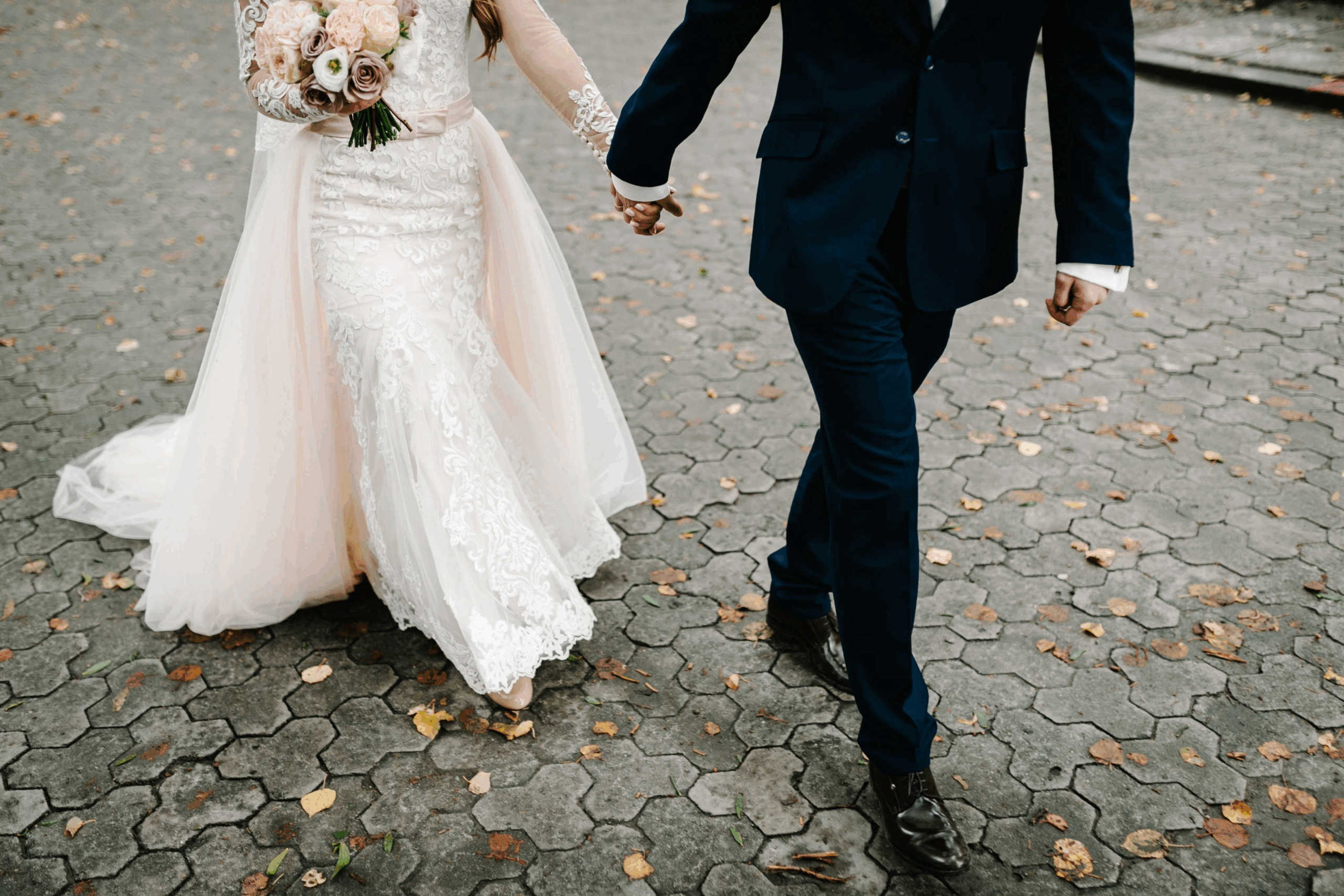 Wedding planning in Williamson County, Tennessee: a bride and groom walking, holding hands.