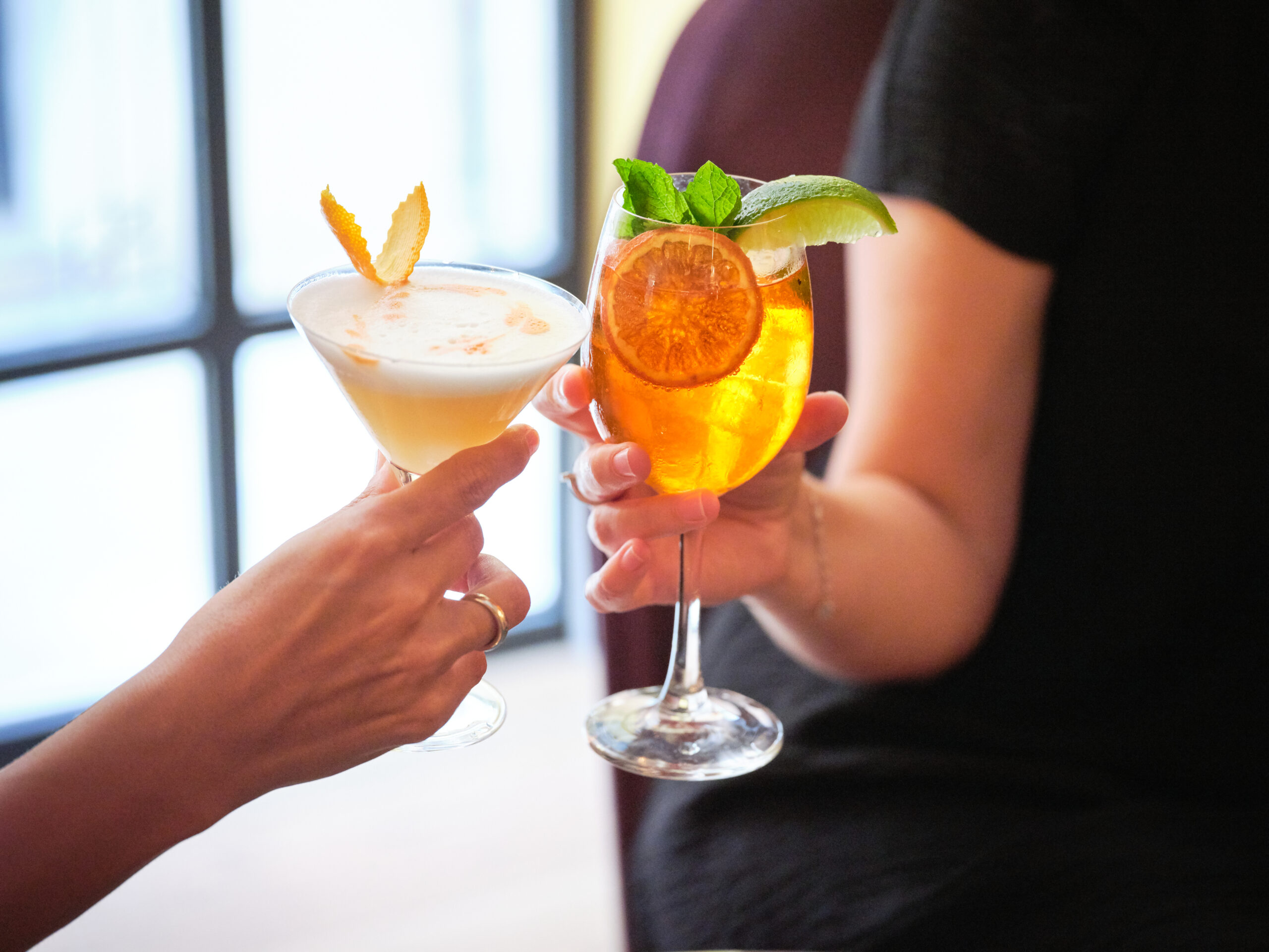 Friends toast happy hour cocktails in Brentwood, Tennessee.