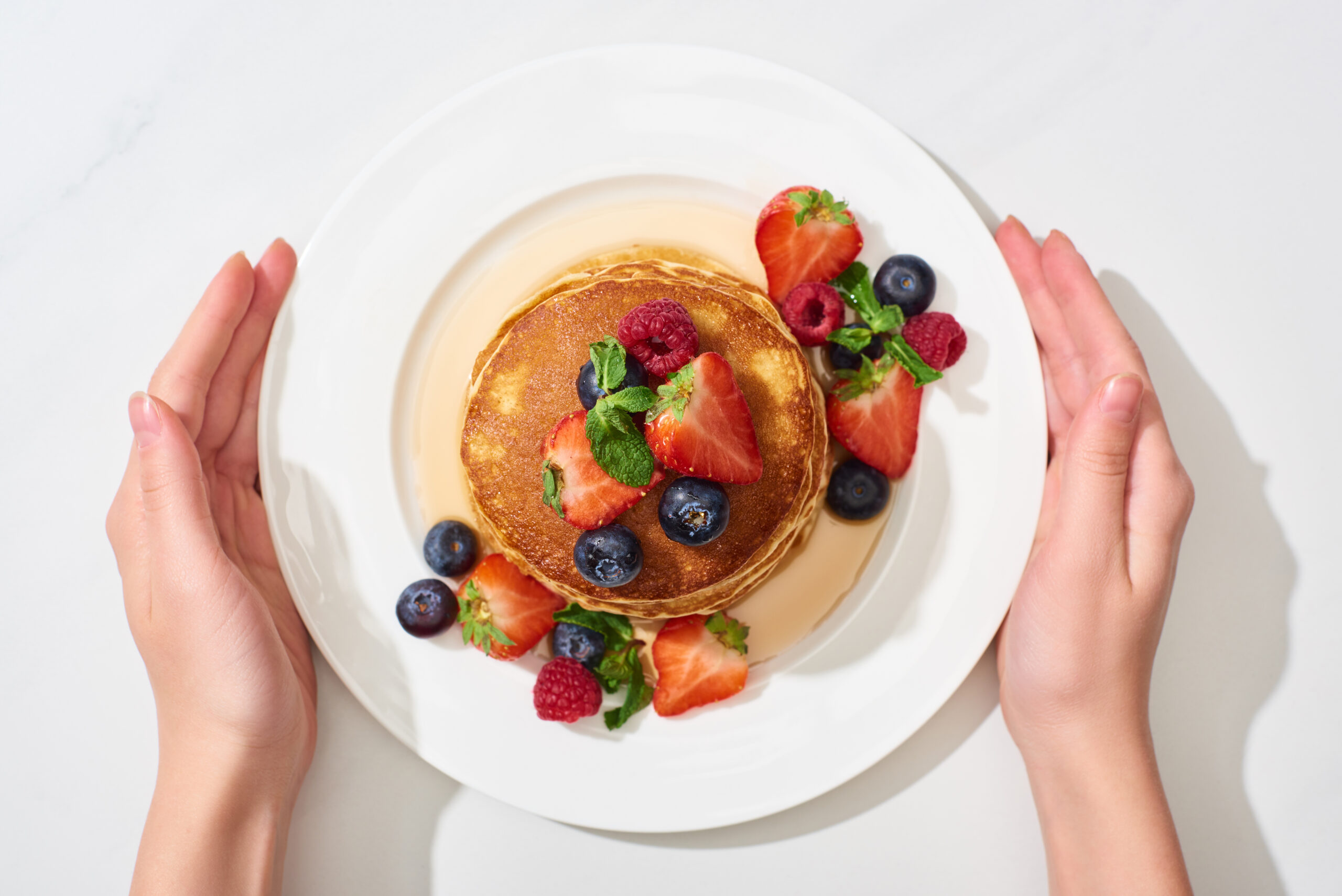 Pancakes with berries are served on a plate at restaurants in Franklin and Brentwood, Tennessee.